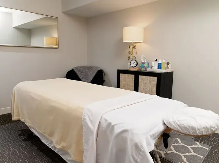 Massage room with a treatment table and warm lamp