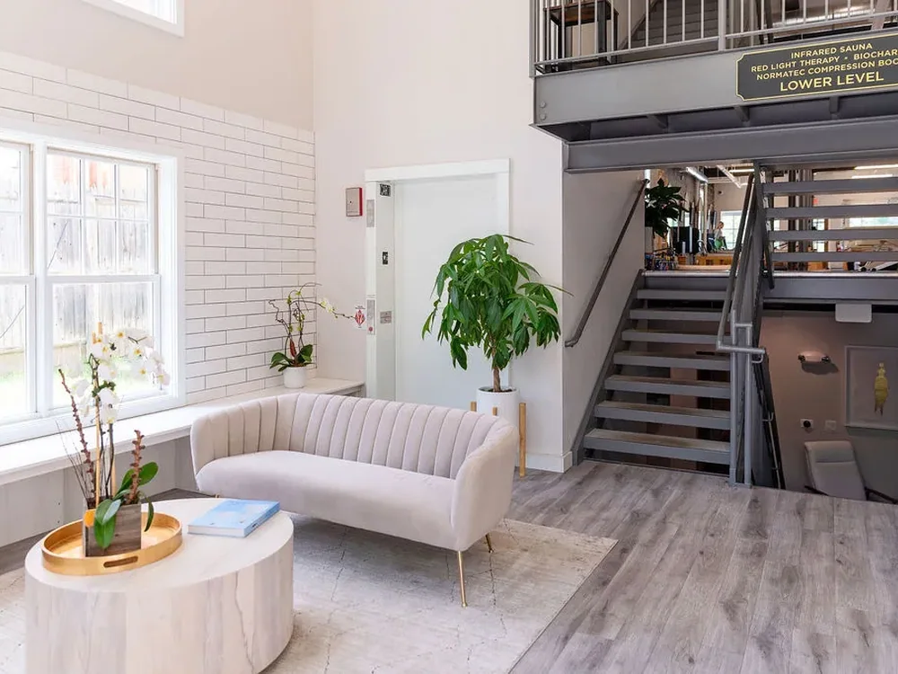 The Wellness Solutions reception lounge and open staircase in Lake Forest