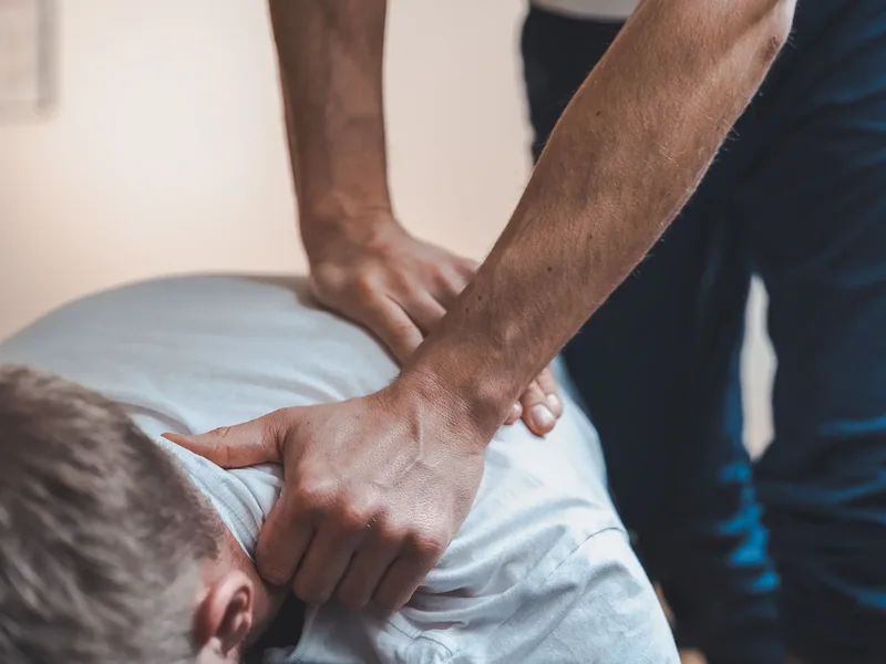 Therapist performing a side-lying spinal technique