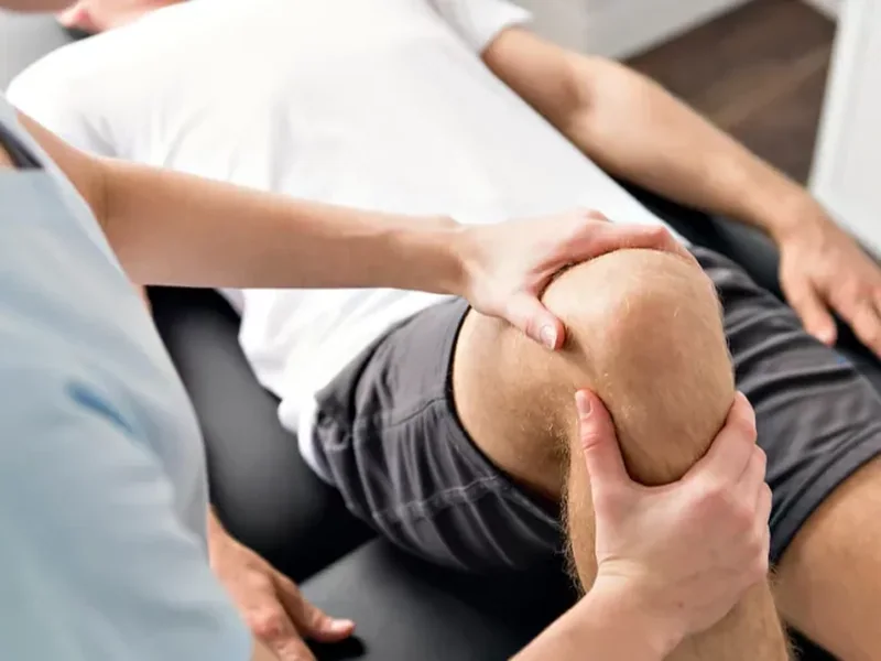 Manual therapy applied to a client's knee