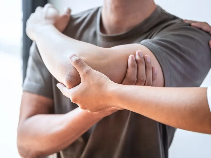 Therapist mobilising a client's shoulder and arm