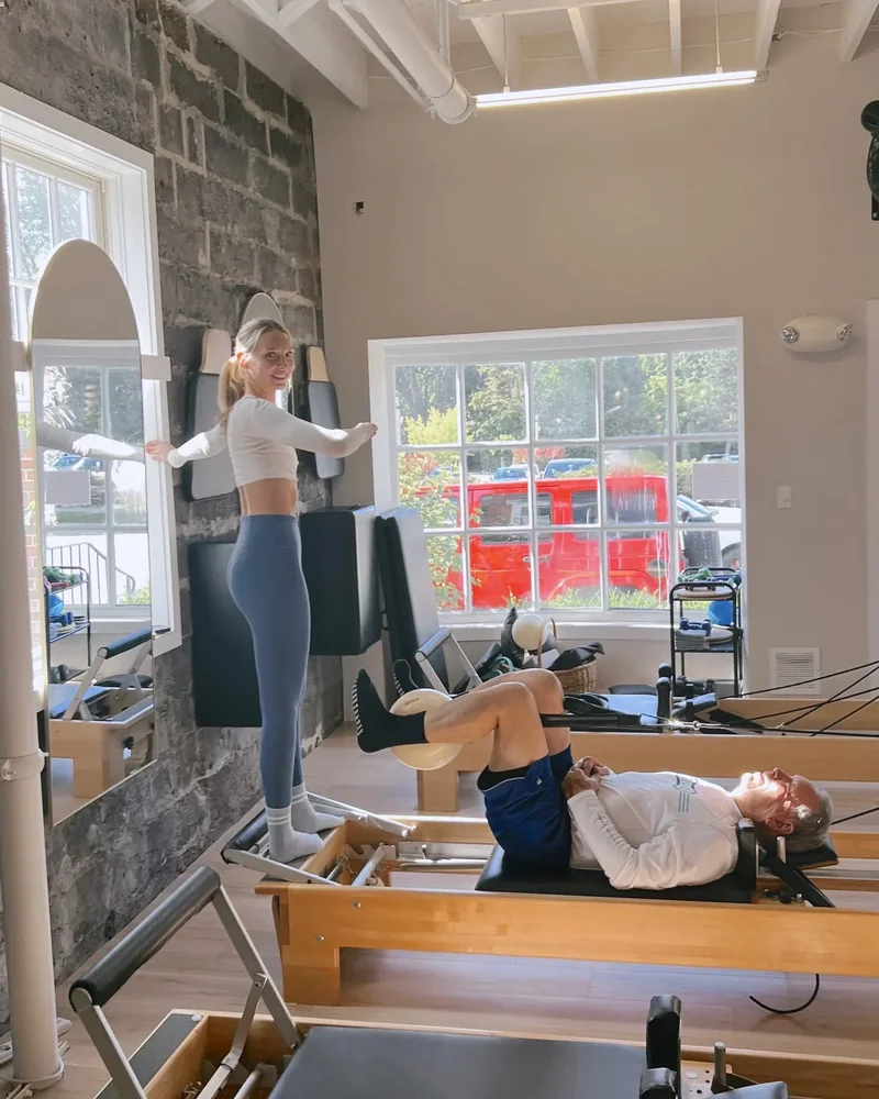 Instructor guiding a client on the wall tower in the studio