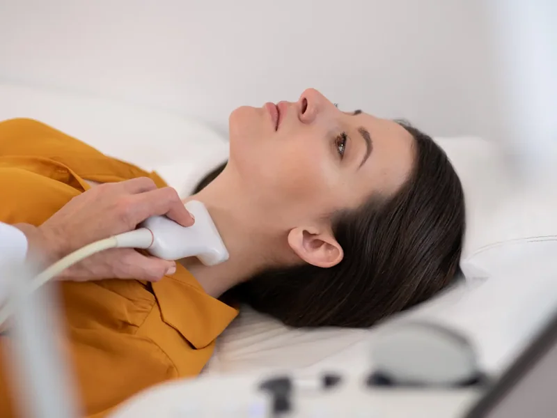Client receiving laser treatment to the neck