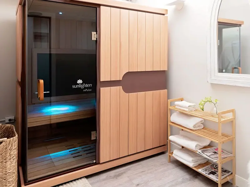 The Sunlighten infrared sauna cabin in a treatment room
