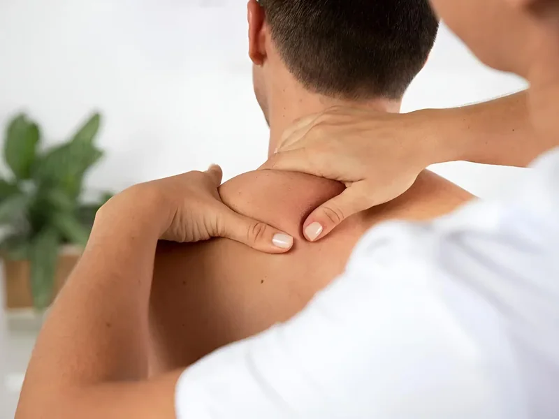 Close-up of hands performing neck and shoulder manual therapy