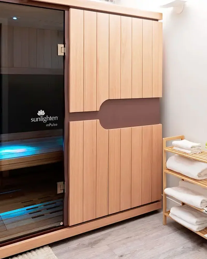The Sunlighten infrared sauna cabin in a treatment room