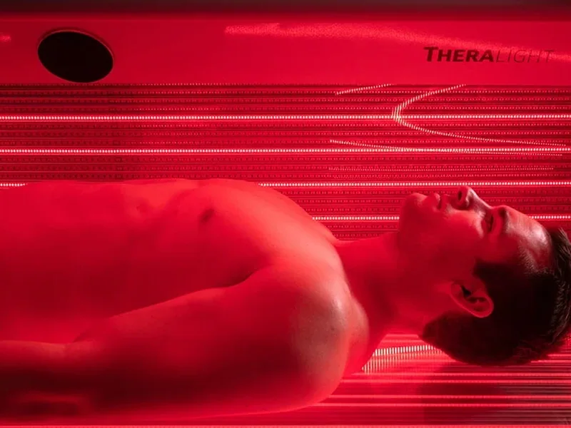 Client lying inside the TheraLight 360 red light bed
