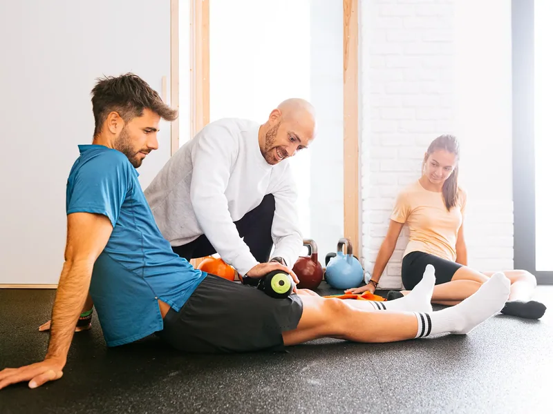 Trainer working with athletes on the floor